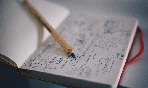 App interface wireframes and user experience sketches in a notebook