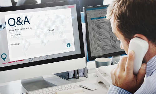 Developer comparing an iPhone app with its simulator preview on a MacBook