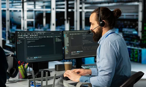 Developer reviewing code and monitoring system performance